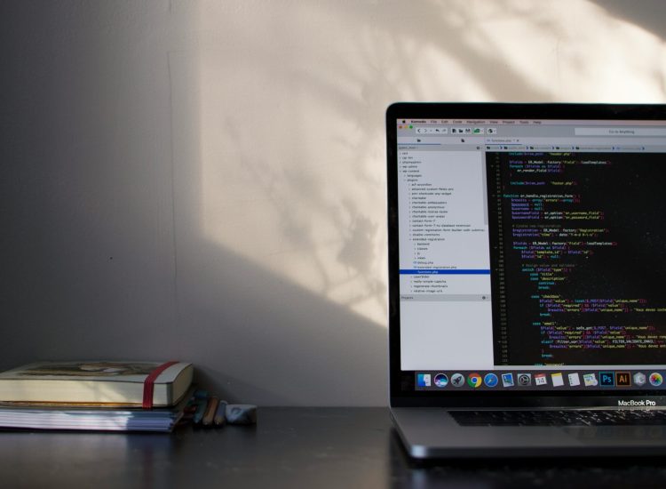 Laptop displaying code with sunlight on the wall, symbolizing local SEO services technical optimization.